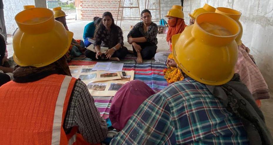 Construction workers in hard hats reviewing photo cards