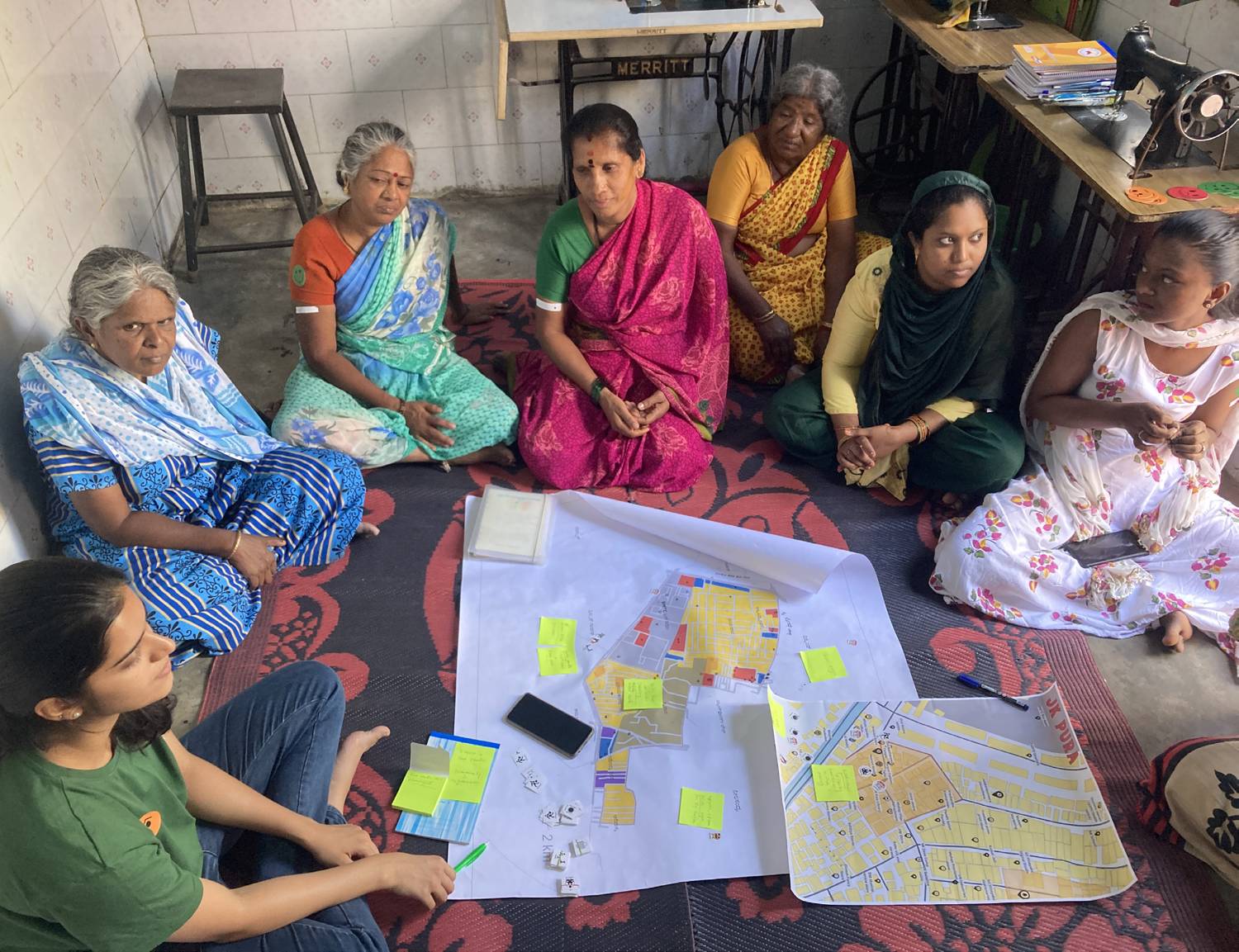Women from a Bengaluru settlement mapping their ward on a printed map with sticky notes
