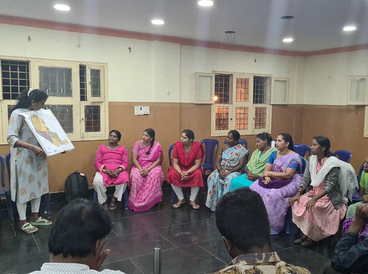 Women in a circle at a community knowledge-sharing session