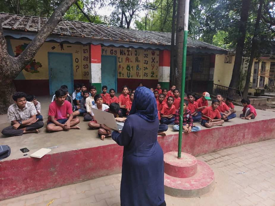 Children at a waste awareness session in a school ground